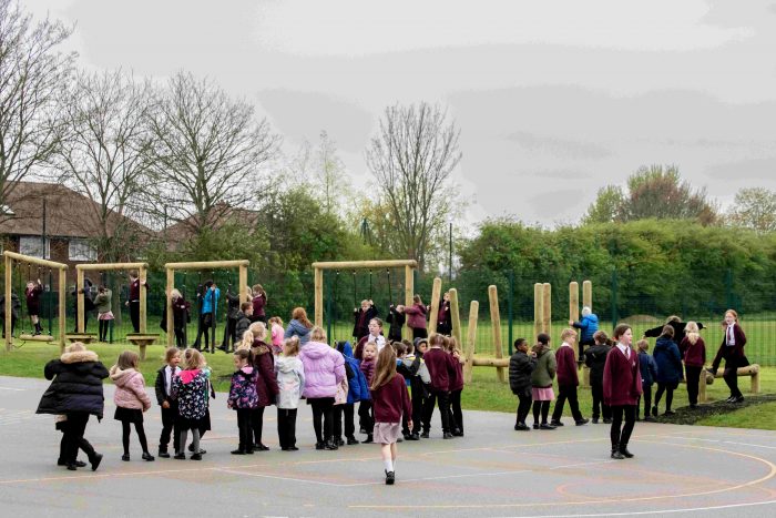 Children queue for Trim Trail